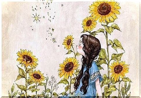 Smiling girl among sunflowers