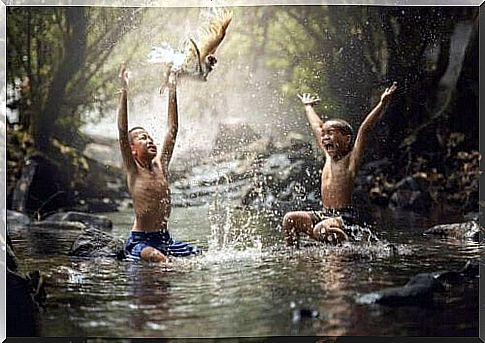 Boys play in the river as part of cultural evolution