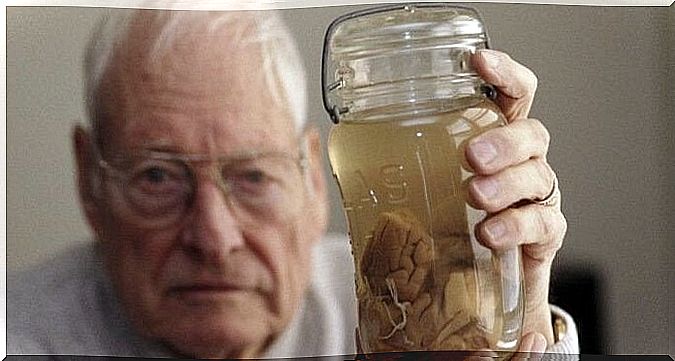 Man holding up glass jar.