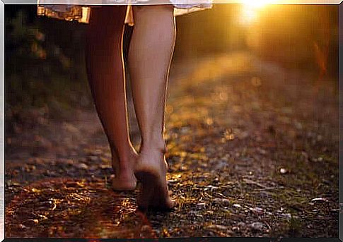 Woman walking barefoot.