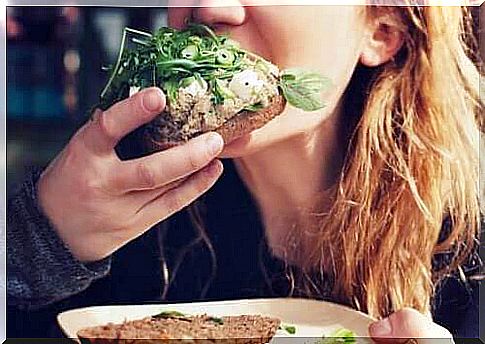 Woman eating sandwich.